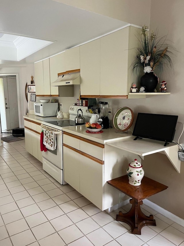 kitchen with white appliances, crown molding, light tile patterned floors, cream cabinetry, and range hood