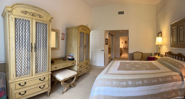 carpeted bedroom featuring a towering ceiling