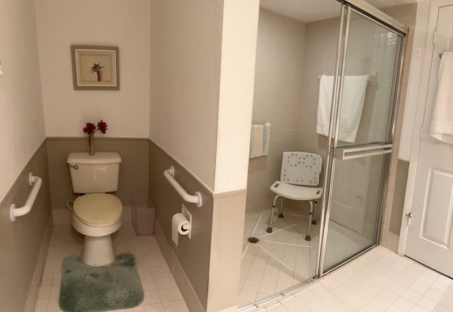 bathroom featuring tile patterned floors, toilet, and an enclosed shower