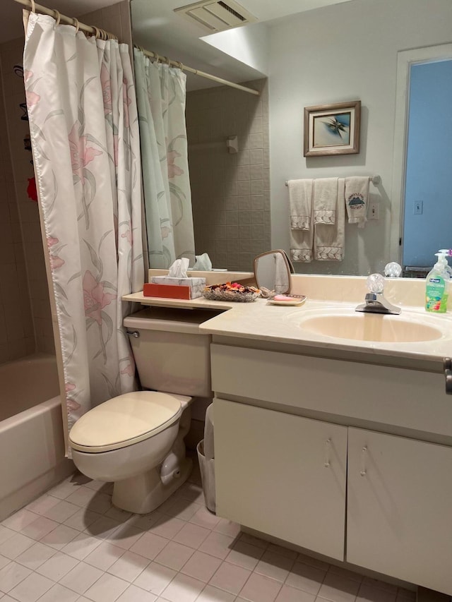 full bathroom with tile patterned floors, shower / tub combo with curtain, vanity, and toilet