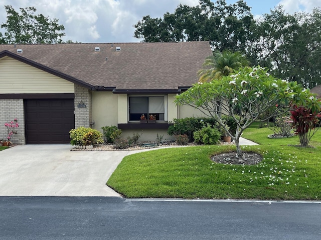 ranch-style home with a front lawn and a garage