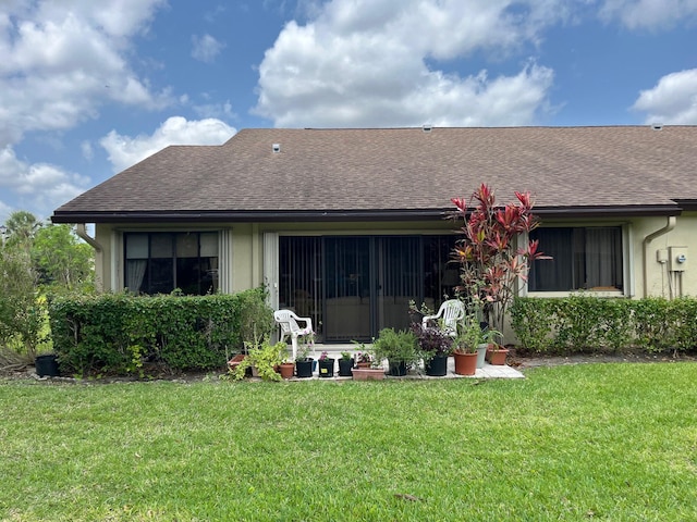 rear view of house with a lawn