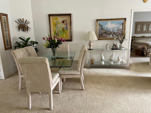 dining space featuring light colored carpet