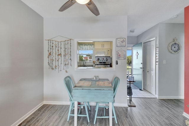 unfurnished dining area featuring ceiling fan and light wood-type flooring