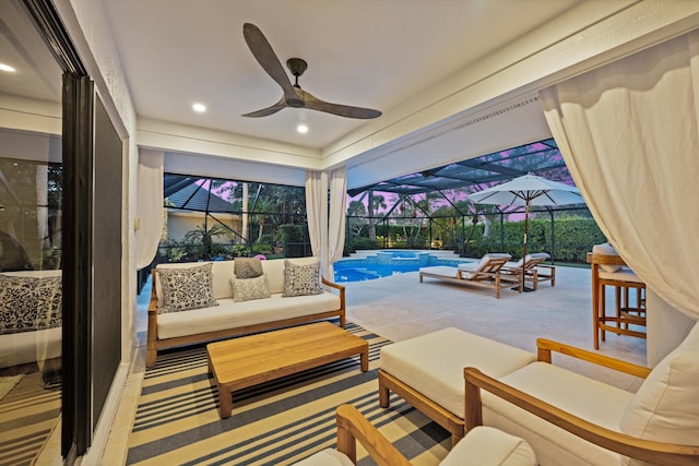 exterior space featuring outdoor lounge area, ceiling fan, and glass enclosure