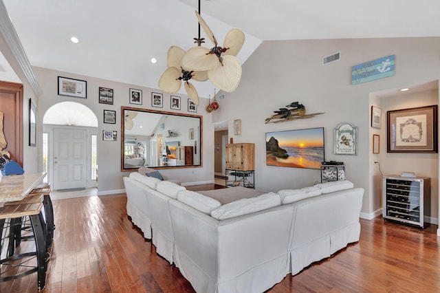 living room featuring hardwood / wood-style floors, high vaulted ceiling, wine cooler, and ceiling fan