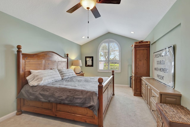 carpeted bedroom featuring ceiling fan and vaulted ceiling