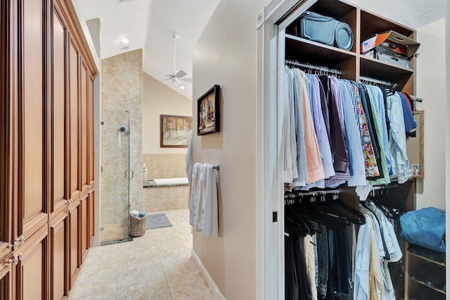 walk in closet with ceiling fan, light tile patterned flooring, and lofted ceiling