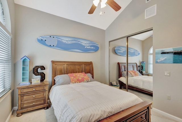 carpeted bedroom featuring vaulted ceiling, a closet, and ceiling fan