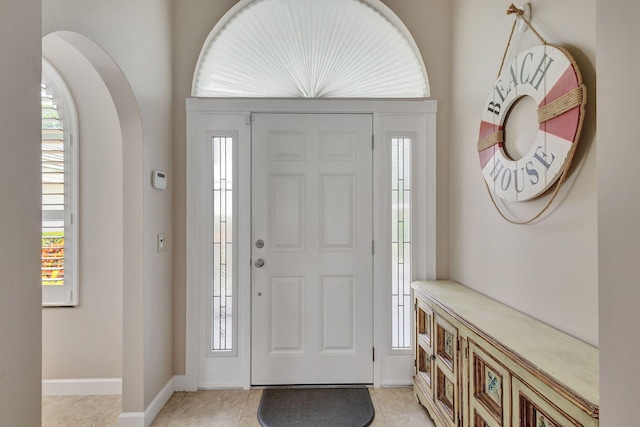 foyer entrance featuring a healthy amount of sunlight and light tile patterned flooring