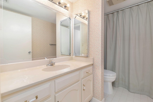 bathroom featuring tile patterned flooring, vanity, and toilet