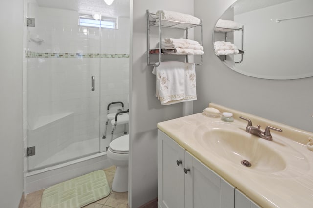 full bathroom with tile patterned floors, toilet, a stall shower, and vanity