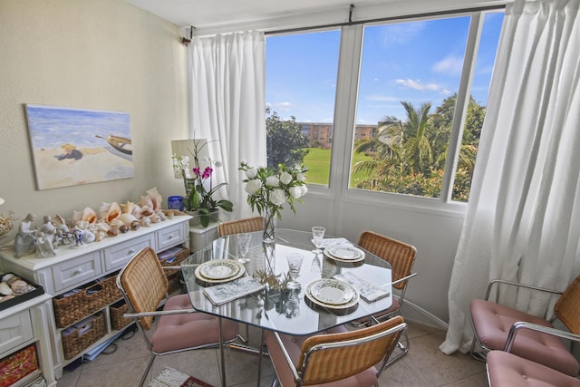 dining room featuring plenty of natural light and light tile patterned flooring