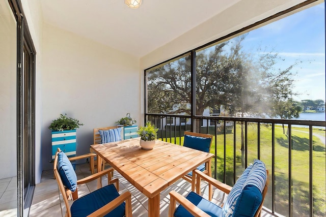 sunroom / solarium with a healthy amount of sunlight and a water view