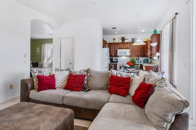 living room with light tile patterned flooring and a healthy amount of sunlight