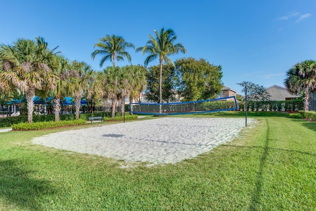 view of community with volleyball court and a yard