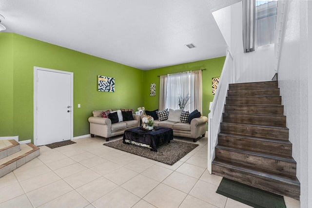 living room with plenty of natural light and light tile patterned flooring