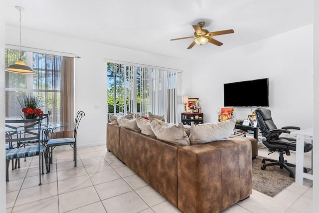 living room featuring ceiling fan, a healthy amount of sunlight, and light tile patterned floors