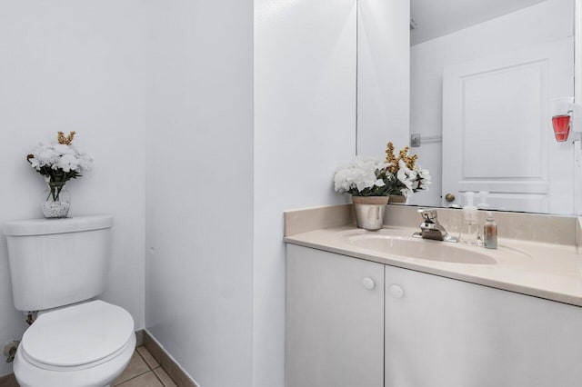 bathroom with tile patterned flooring, vanity, and toilet