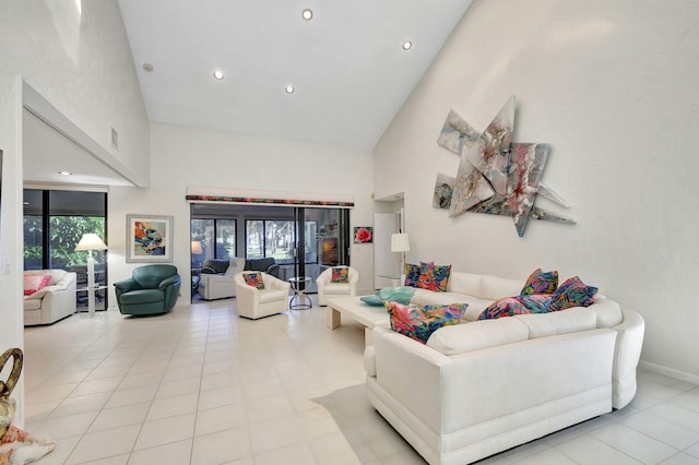 living room featuring a wealth of natural light, high vaulted ceiling, and light tile patterned flooring