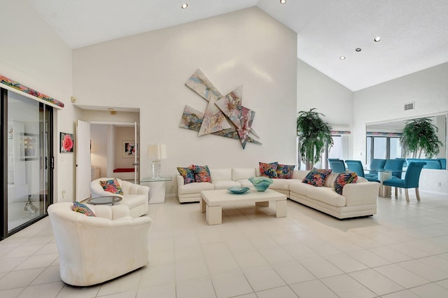 living room featuring high vaulted ceiling and light tile patterned floors