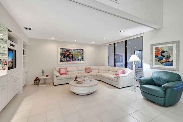 tiled living room featuring built in features