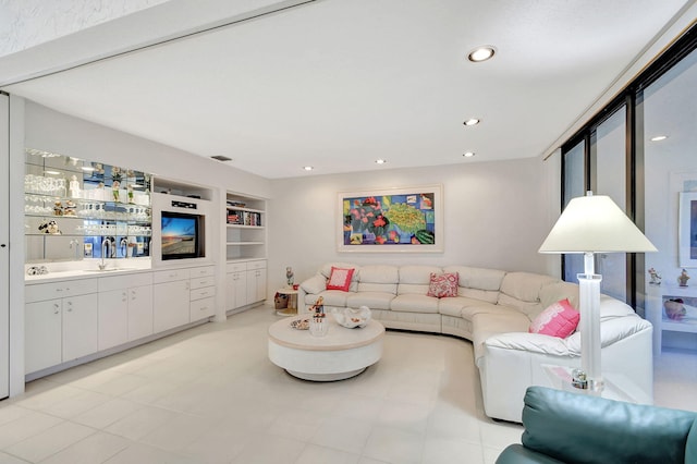 living room featuring built in features and sink