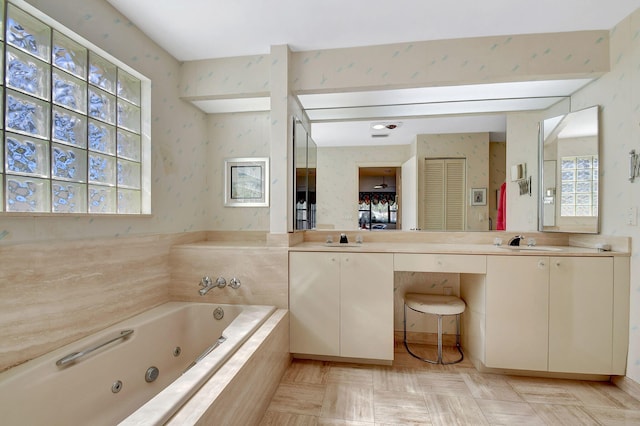 bathroom featuring vanity and tiled tub