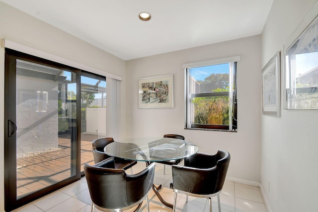 dining space with plenty of natural light and light tile patterned floors