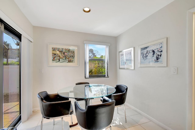 dining space with light tile patterned flooring and a healthy amount of sunlight