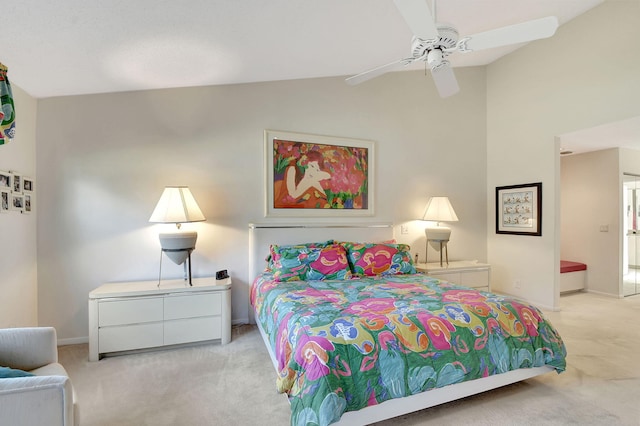 carpeted bedroom featuring ensuite bath, ceiling fan, and vaulted ceiling