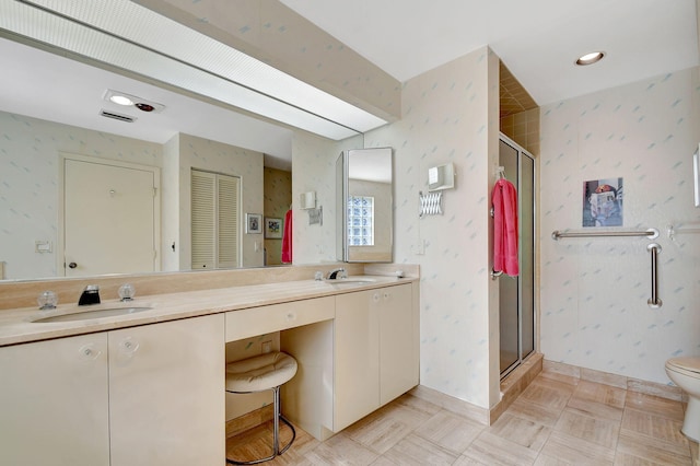 bathroom featuring vanity, toilet, and an enclosed shower