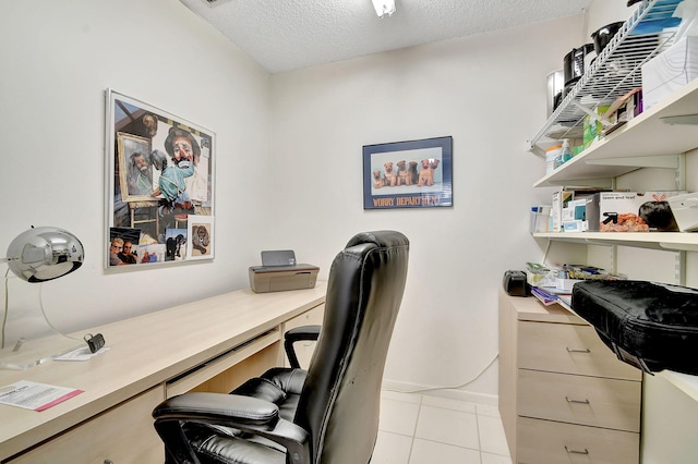 home office with light tile patterned floors and a textured ceiling