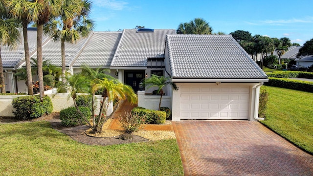 view of front of property featuring a garage and a front lawn