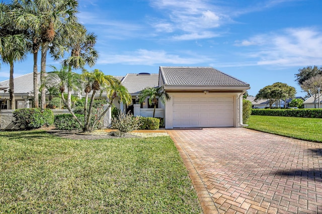 view of front of property featuring a front yard and a garage