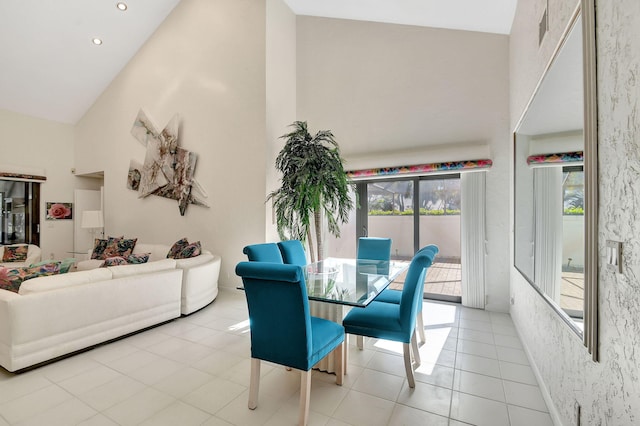 dining space featuring high vaulted ceiling and light tile patterned floors