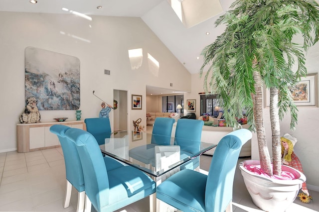 tiled dining area featuring high vaulted ceiling