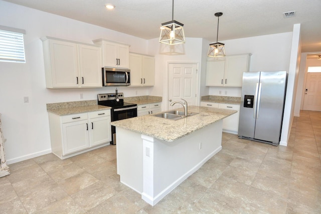 kitchen with white cabinetry, sink, an island with sink, pendant lighting, and appliances with stainless steel finishes