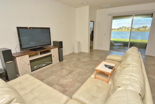 living room featuring a water view and golf simulator