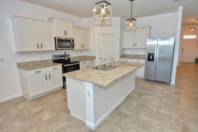 kitchen with stainless steel appliances, a kitchen island with sink, sink, pendant lighting, and white cabinetry