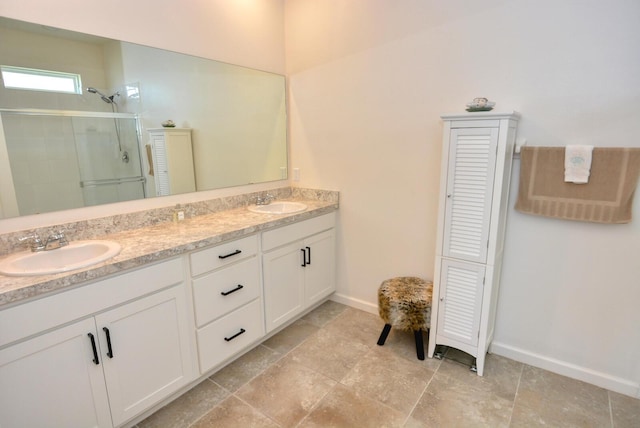 bathroom with vanity and a shower with door