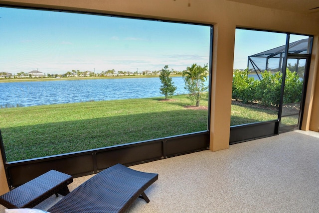 sunroom / solarium featuring a water view and a wealth of natural light