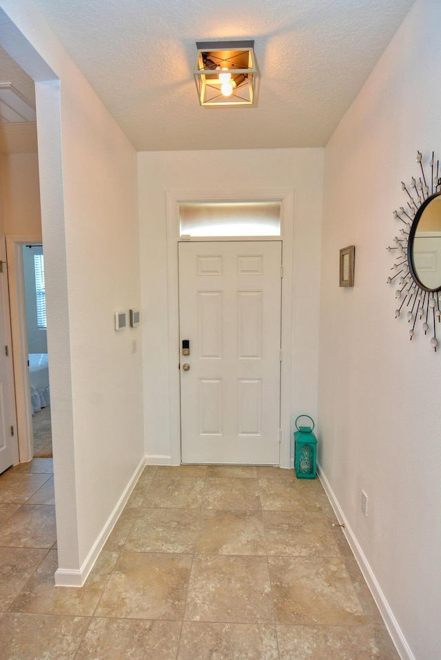 foyer entrance featuring a textured ceiling