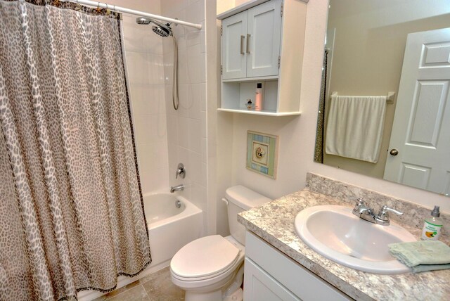 full bathroom featuring tile patterned flooring, vanity, shower / bath combination with curtain, and toilet