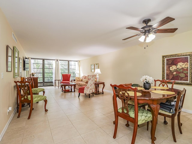 dining space with ceiling fan, expansive windows, and light tile patterned floors