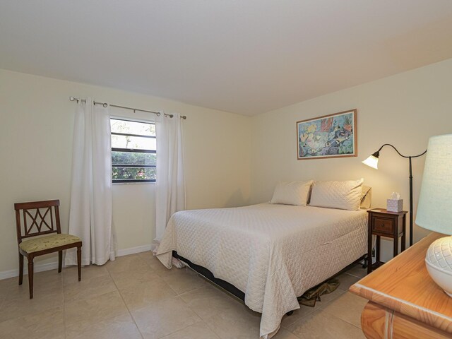 bedroom with a closet and light tile patterned floors