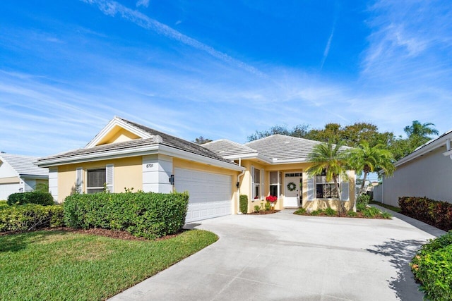 ranch-style house featuring a front yard and a garage