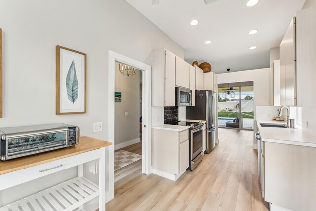 office featuring ceiling fan and light hardwood / wood-style flooring