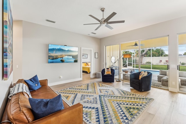 living room featuring hardwood / wood-style flooring and ceiling fan