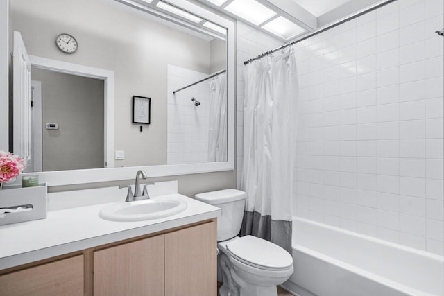 full bathroom with vanity, shower / bath combo, and toilet